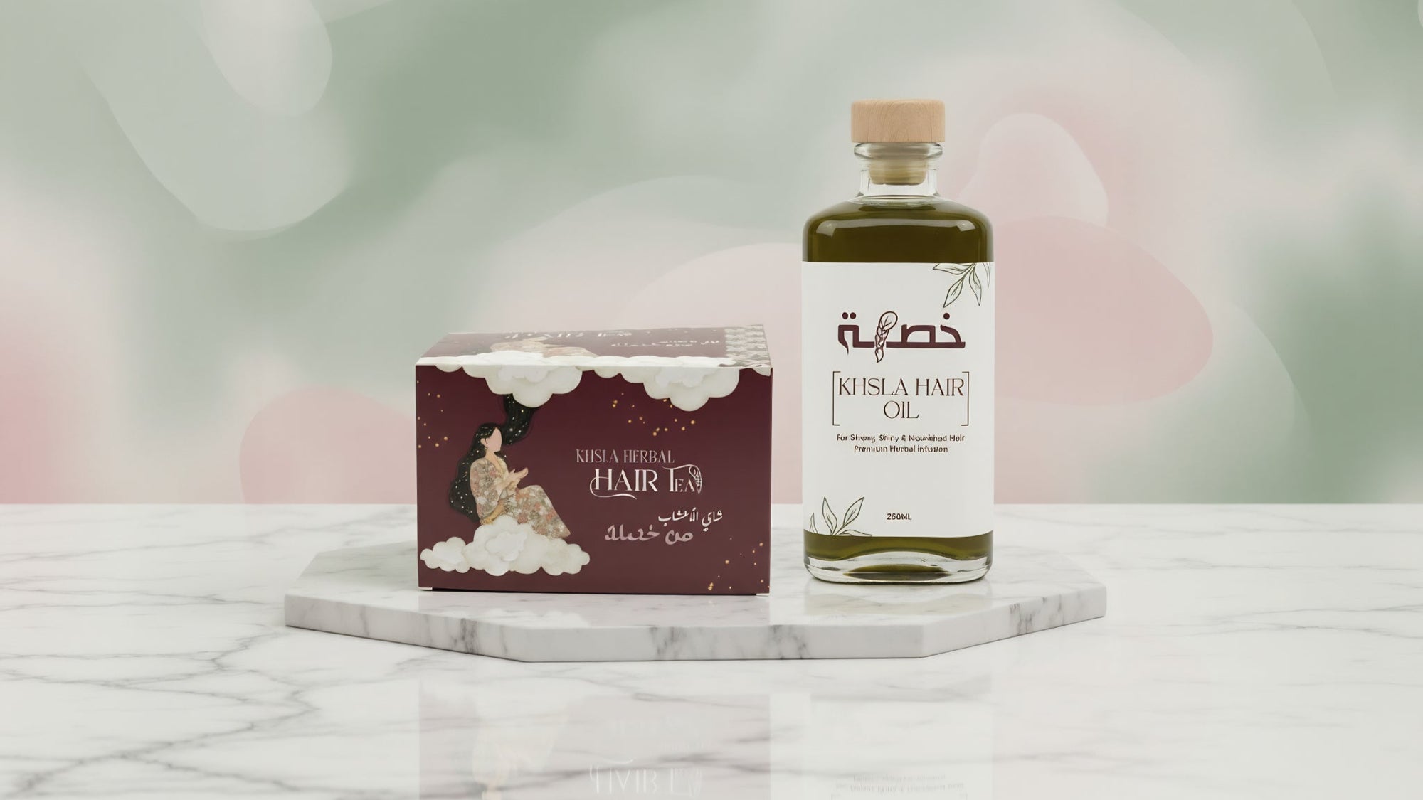 Bottle and box of hair oil on a marble surface with a soft, blurred background
